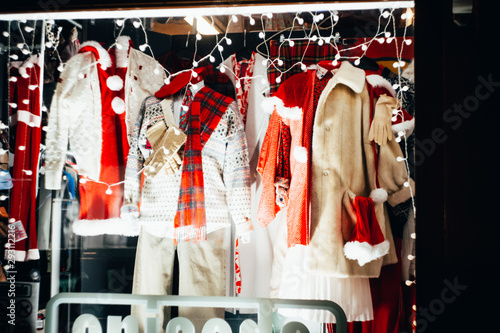 An urban storefront with a warm winter clothing collection on Christmas Eve. photo