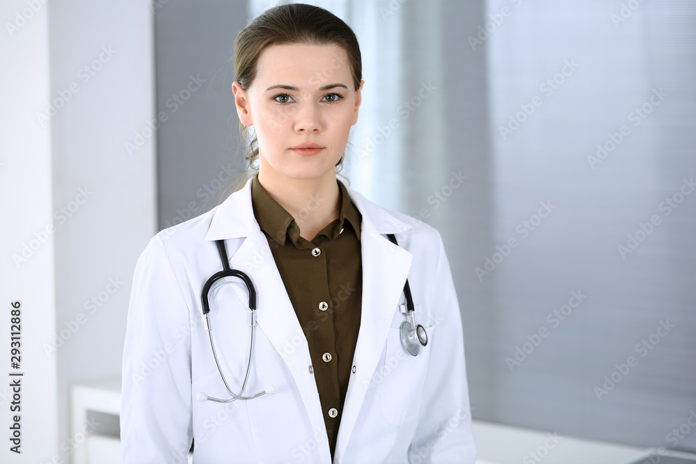 Doctor woman happy and cheerful while standing in hospital office. Perfect medical service in clinic. Medicine and healthcare concept Doctor woman happy and cheerful while standing in hospital office. Perfect medical service in clinic. Medicine and healthcare concept