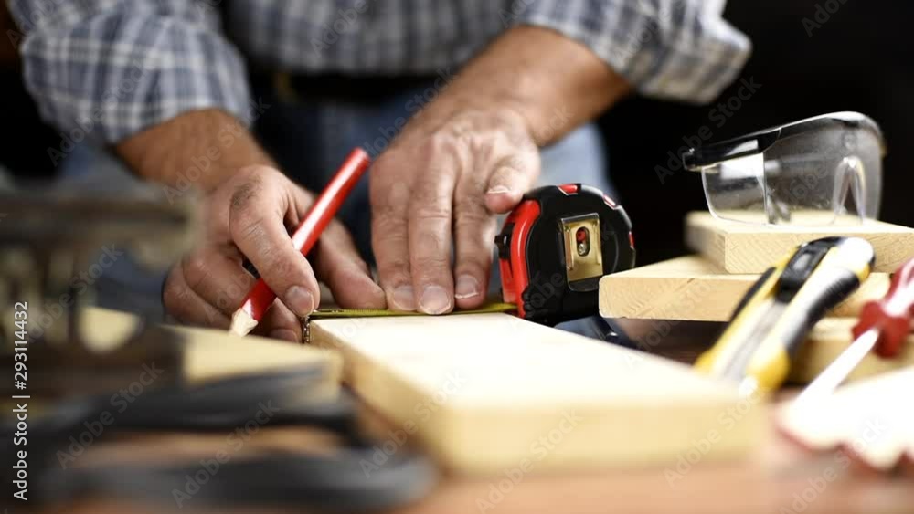 Adult carpenter craftsman with the meter takes the measurement on a wooden table. Housework do it yourself. Footage. Adult carpenter craftsman with the meter takes the measurement on a wooden table. Housework do it yourself. Footage.