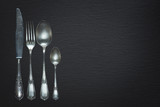 Vintage cutlery on black background