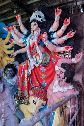 Clay idol of Goddess Devi Durga is in preparation for the upcoming Durga Puja festival at a pottery studio in Kolkata, West Bengal, India.	 photo