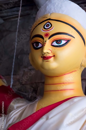 Clay idol of Goddess Devi Durga is in preparation for the upcoming Durga Puja festival at a pottery studio in Kolkata, West Bengal, India.	 photo