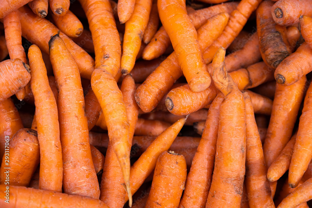 Pile of organic sweet carrots top view. Perfect for nutritious salad or healthy snack Pile of organic sweet carrots top view. Perfect for nutritious salad or healthy snack