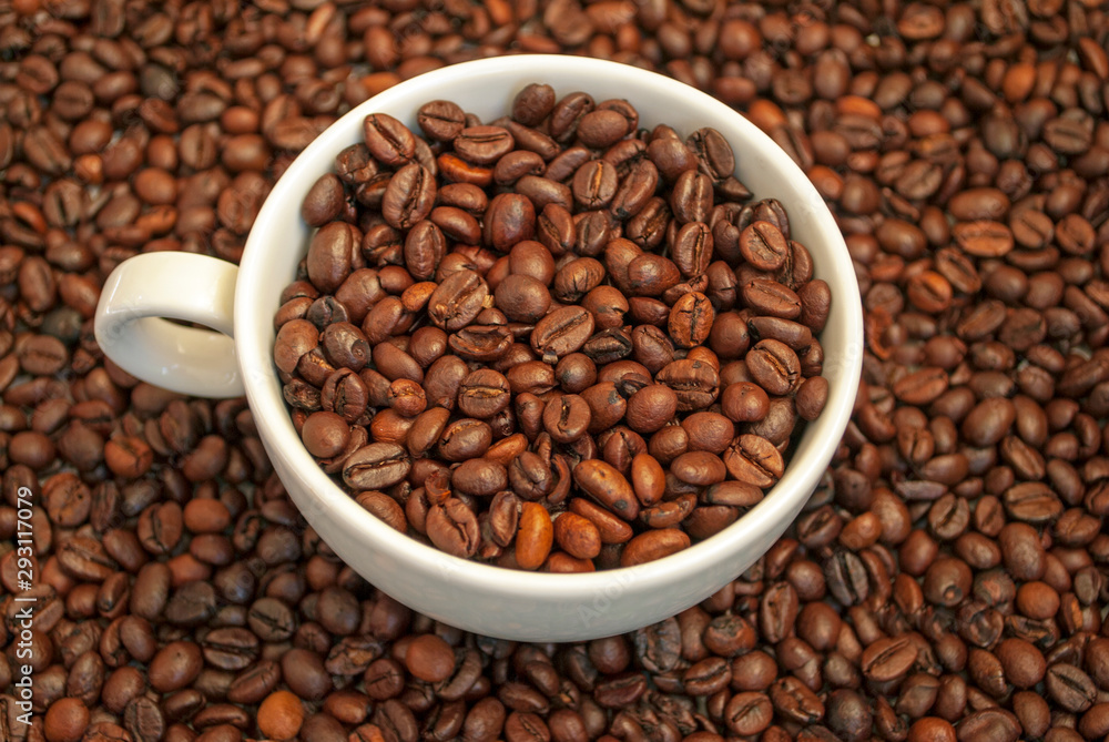 cup filled with coffee beans on a coffee background