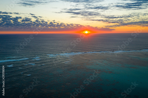Aerial photo of sunset over sea and coral reef © Richard Carey