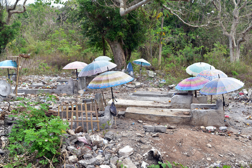 Umbrellas over graves and coffins at Nusa Lembongan cemetery  Indonesia