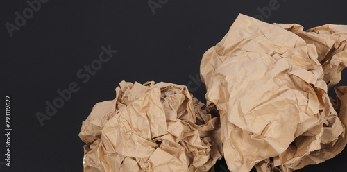 Crumpled brown paper.It is mauled on black background. photo