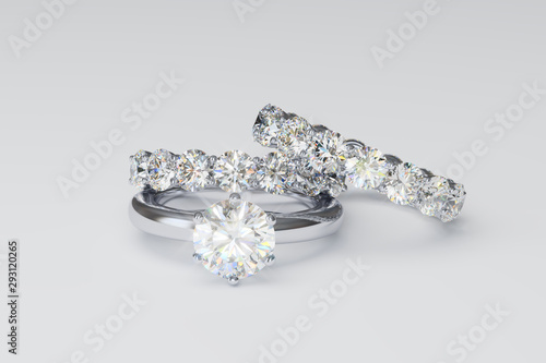 Solitaire diamond engagement ring, two diamond eternity bands on white background