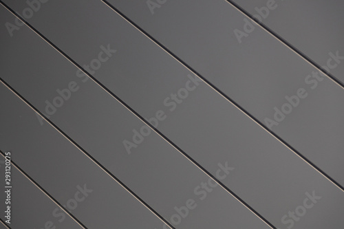 Close-up of smooth matte grey siding wall of building