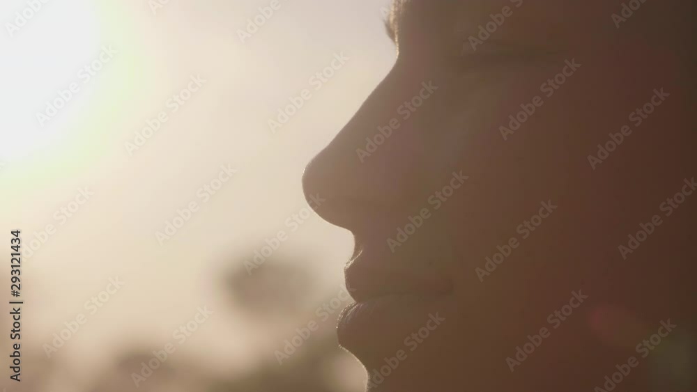 Authentic close up shot of young woman is enjoying a nature with a sunshine. Authentic close up shot of young woman is enjoying a nature with a sunshine.