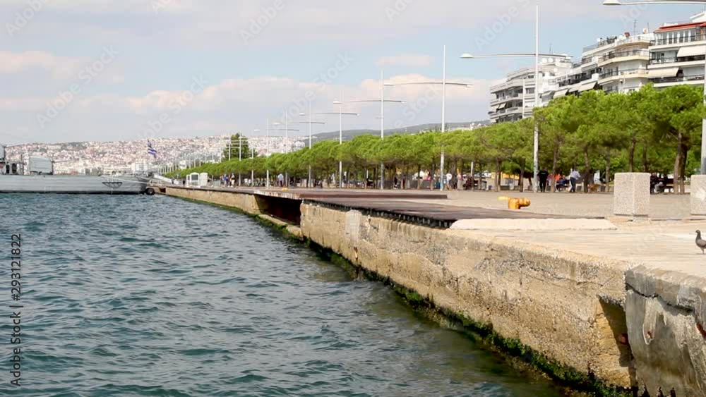 The coast of Thessaloniki city, Greece, clouds over blue sky and residential buildings The coast of Thessaloniki city, Greece, clouds over blue sky and residential buildings