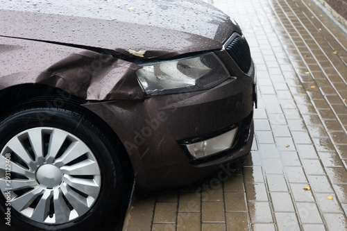 The body of the car in an accident. Crumpled wing. Cloudy autumn rain.