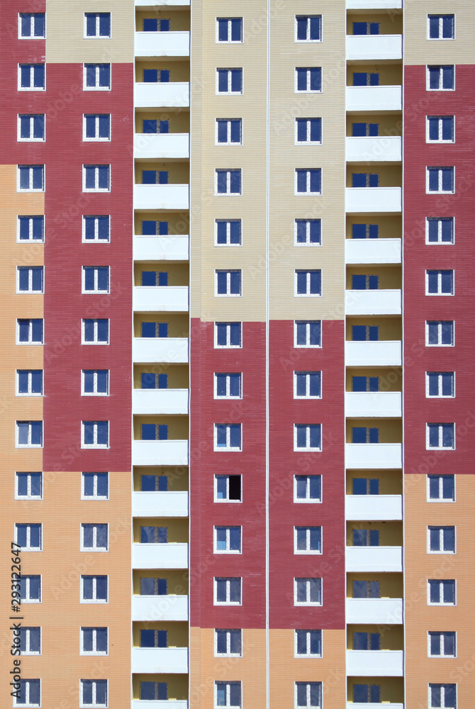 Kiev, Ukraine - June 10, 2017: Texture and background with building and windows. The facade of a new multi-storey building. A new-build multi-storey housing estate