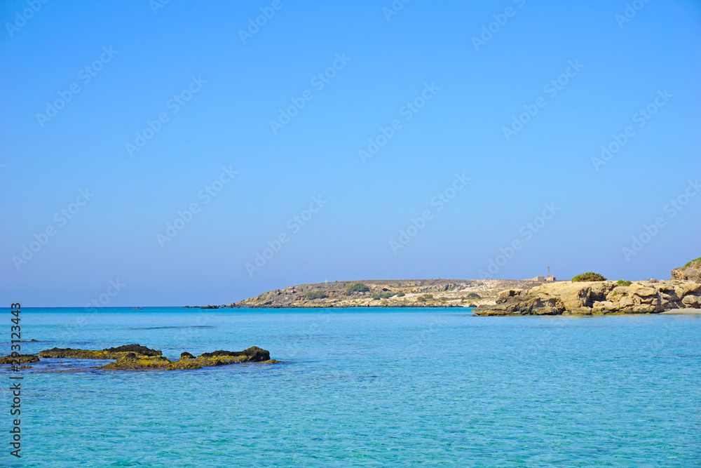 Amazingly clear blue water on the shore in Elafonisi on the island of Crete, Greece.