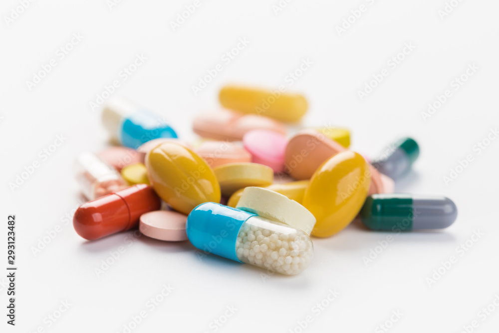 Assorted pharmaceutical medicine pills, tablets and capsules.Heap of assorted various medicine tablets and pills different colors on white background. Top view.Copy space Assorted pharmaceutical medicine pills, tablets and capsules.Heap of assorted various medicine tablets and pills different colors on white background. Top view.Copy space