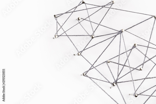 A large grid of pins connected with string. Communication, netwA large grid of pins connected with string. Communication, network conceptork concept