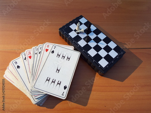 chess and playing cards on the table