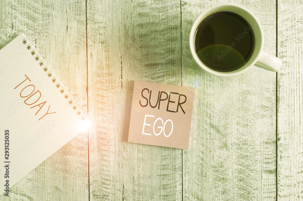 Conceptual hand writing showing Super Ego. Concept meaning The I or self of any demonstrating that is empowering his whole soul Stationary placed next to a coffee cup above wooden table - obrazy, fototapety, plakaty 