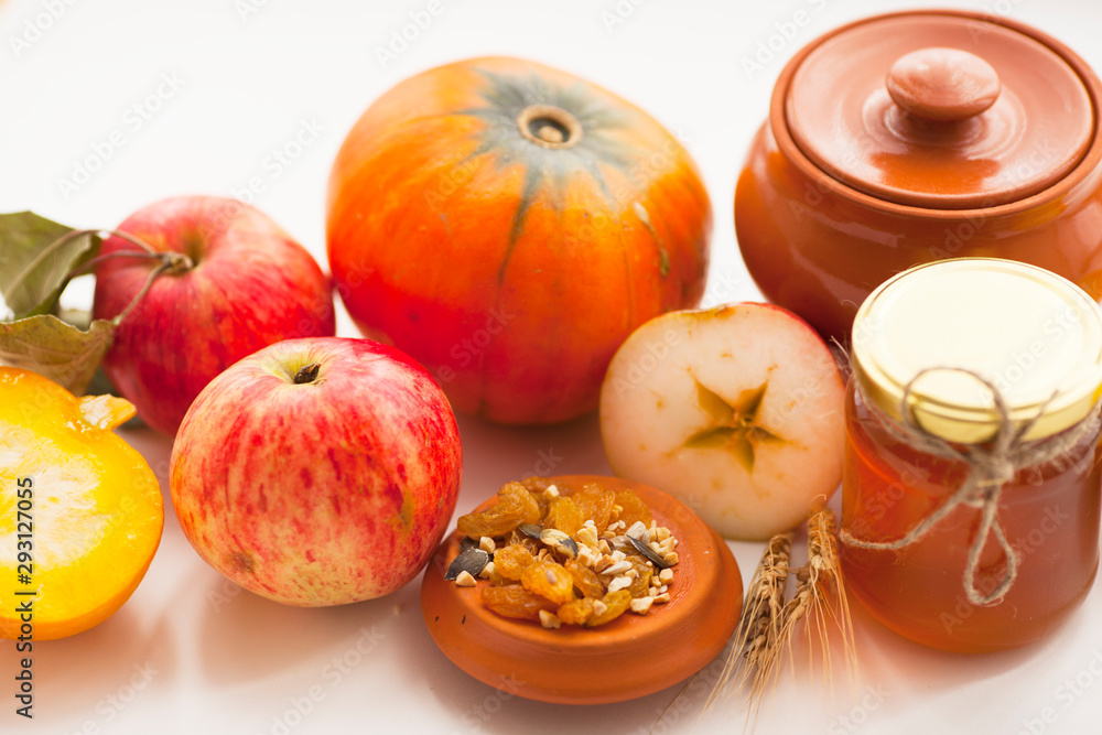 Fresh sliced pumpkin(squash), apples, glass jar of honey isolated on white background. Food, Thanksgiving day concept. Top view. Space for a text. Flat lay. Close up. Fresh sliced pumpkin(squash), apples, glass jar of honey isolated on white background. Food, Thanksgiving day concept. Top view. Space for a text. Flat lay. Close up.