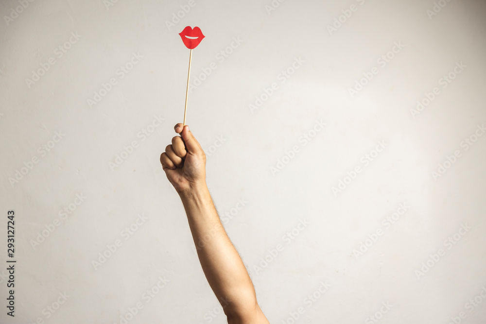 Hand holding Photo booth props, Red lips and rising it up Hand holding Photo booth props, Red lips and rising it up
