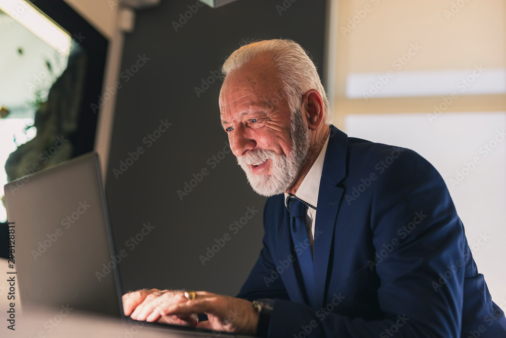 Senior businessman working in a modern office Senior businessman working in a modern office