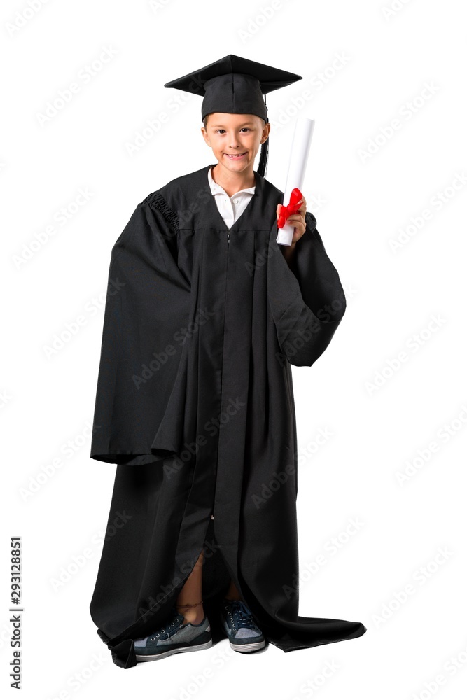 Full body of Little boy graduating posing with arms at hip on isolated white background Full body of Little boy graduating posing with arms at hip on isolated white background