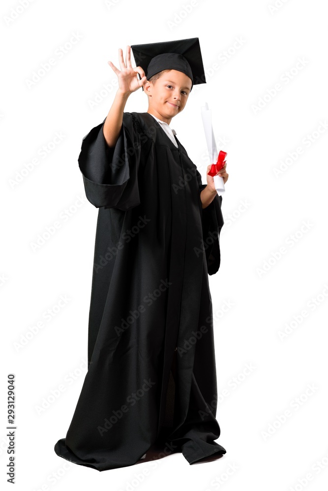 Full body of Little boy graduating showing an ok sign with fingers on isolated white background Full body of Little boy graduating showing an ok sign with fingers on isolated white background