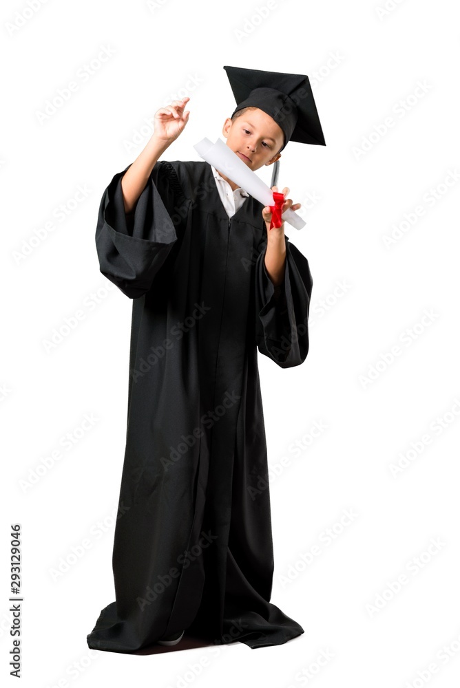 Full body of Little boy graduating smiling and showing victory sign on isolated white background Full body of Little boy graduating smiling and showing victory sign on isolated white background