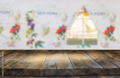 Jewish festival of Sukkot. Traditional succah (hut). Empty wooden old table for product display and presentation. photo