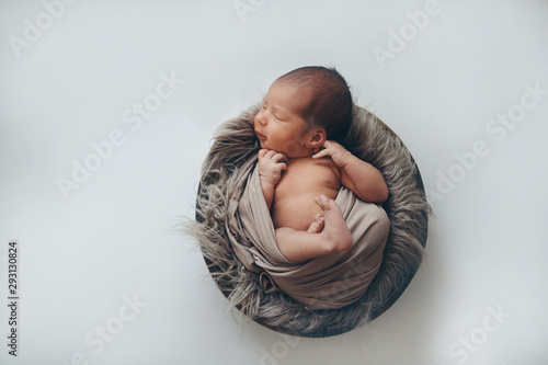newborn baby wrapped in a blanket sleeping in a basket. concept of childhood, healthcare, IVF. Black and white photo