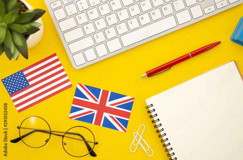 Fototapeta premium American and great britain flags next to empty notebook
