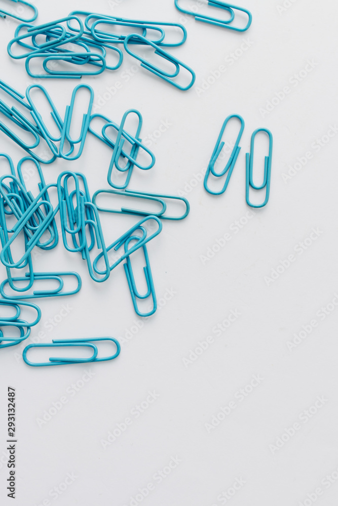 Pile of blue paper clips on blue background Pile of blue paper clips on blue background