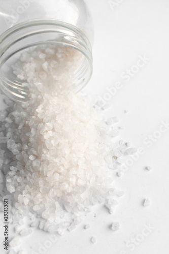 Scattered flavored salt on white background