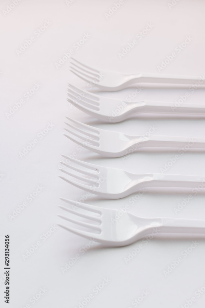 White plastic forks flat lay on white background White plastic forks flat lay on white background