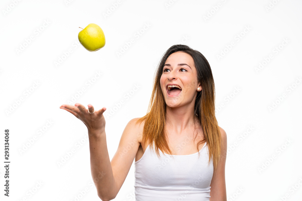Young woman with an apple over isolated white background Young woman with an apple over isolated white background