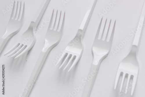 White plastic forks flat lay on white background