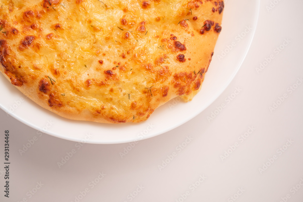 Fresh round cake on white plate on white background. Fresh round cake on white plate on white background.