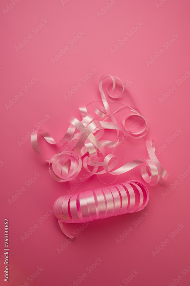 Pink Decorative Ribbons Lie on a Pink Background.