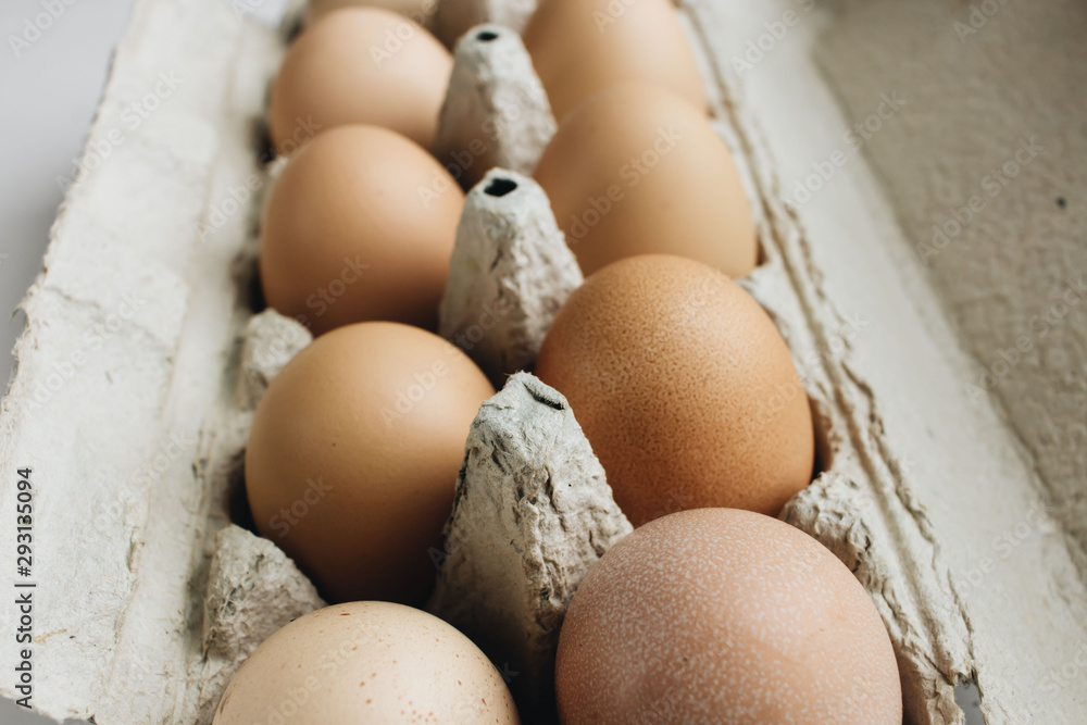 Chicken eggs in cardboard package on white background Chicken eggs in cardboard package on white background