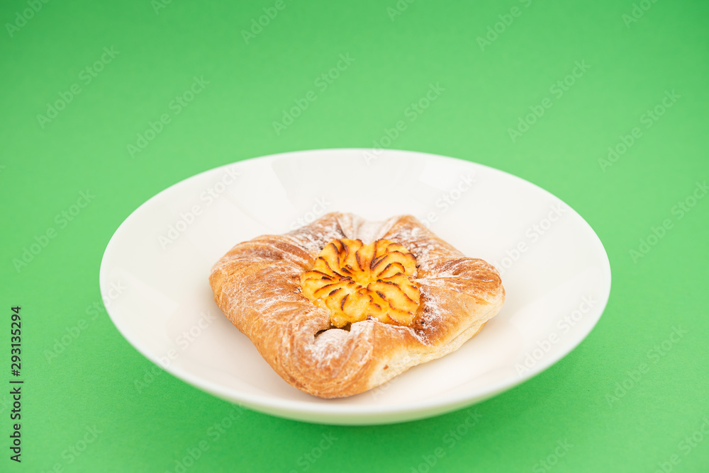 Fresh bun of unusual shape on green background. Fresh bun of unusual shape on green background.