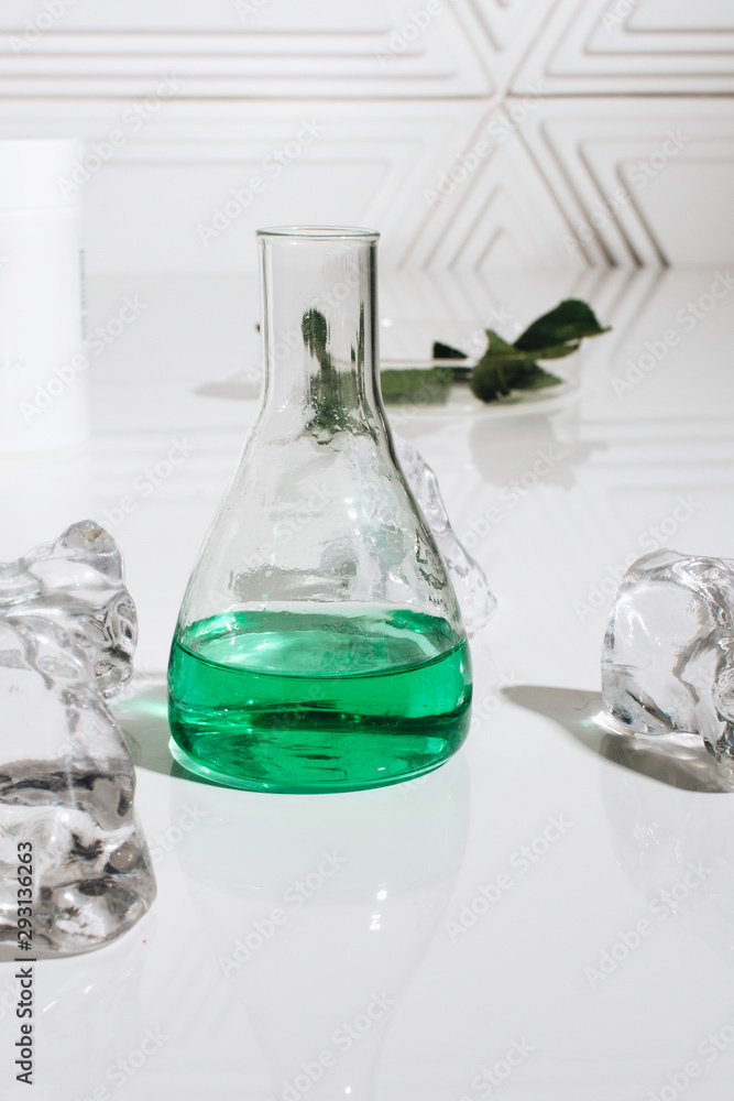Scattered crystals and green liquid in flask Scattered crystals and green liquid in flask