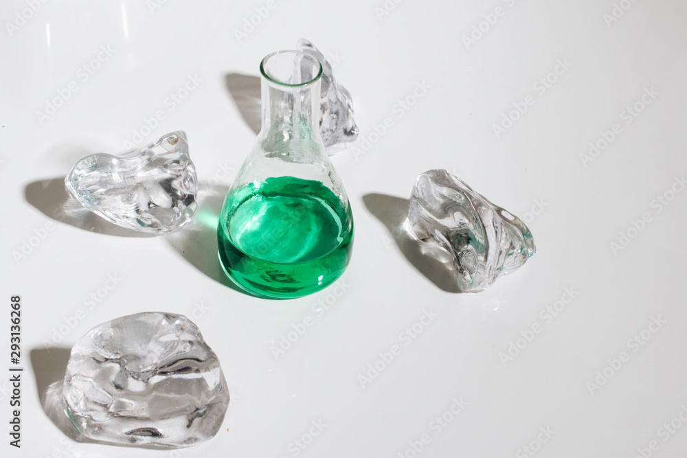 Scattered crystals and green liquid in flask