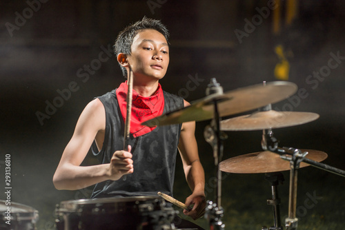 Obraz na plátně young boy as talented rock band drummer