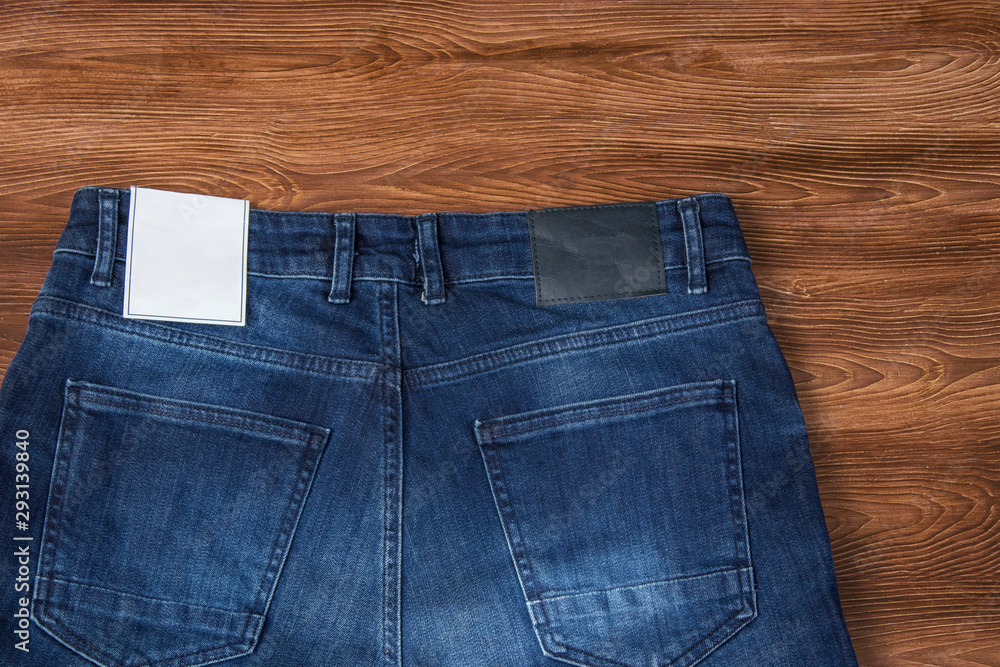 Jeans label mockup, denim texture, isolated wooden background Jeans label mockup, denim texture, isolated wooden background