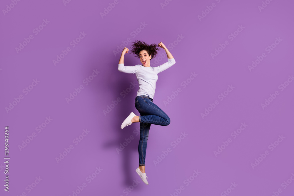 Full length body size photo of white cheerful cute nice charming lovely woman showing you her muscles and power while screaming wearing jeans denim jumping isolated over pastel color background
