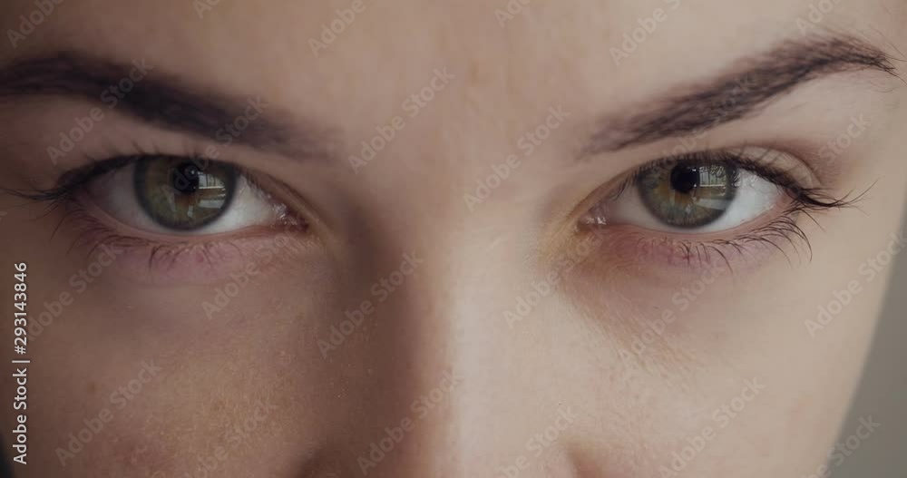 Close-up view on woman blinks and looks away. Close-up view on woman blinks and looks away.