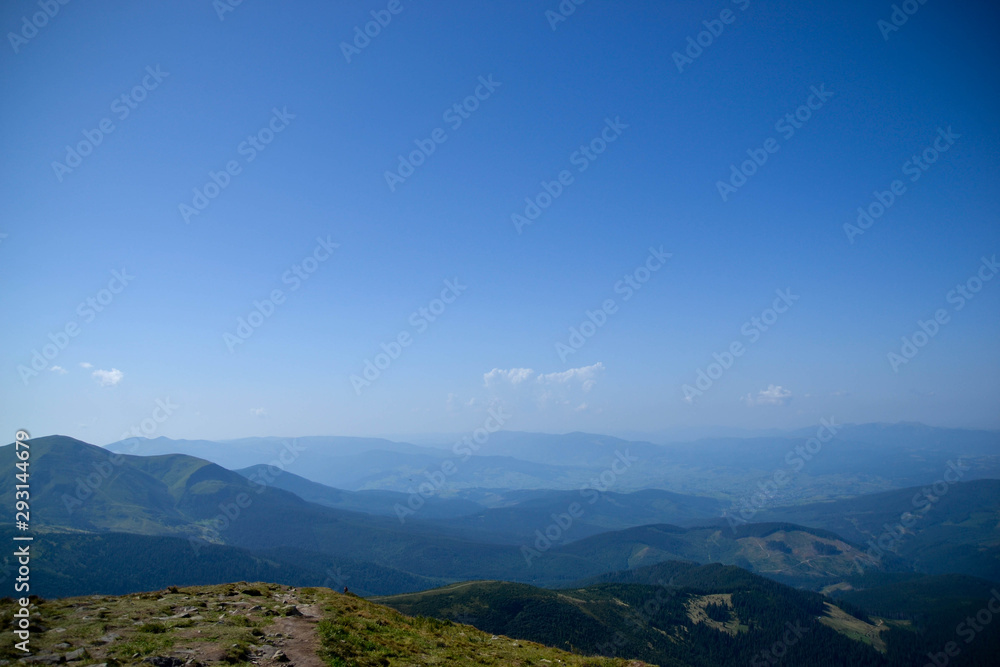 Landscape with mountains view from the top of Hoverla mountain which located in Ukraine with amazing sunny weather and blue sky as nature wallpaper for travel blog with famous places in summer time