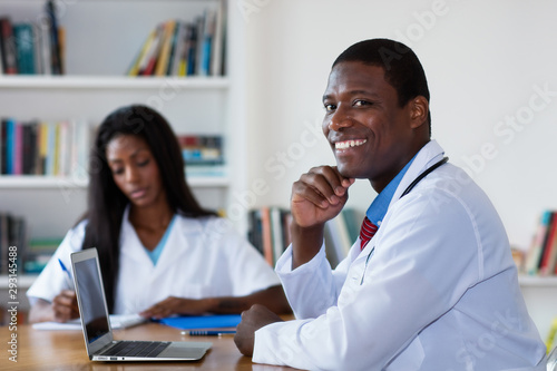 African american doctor at computer with nurse