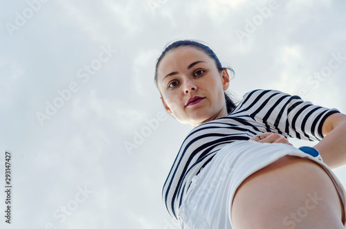 Beautiful sexy girl looking down at the camera, bottom view Stock Photo |  Adobe Stock