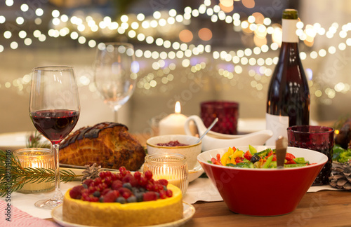 christmas dinner and eating concept - food and drinks on table at home